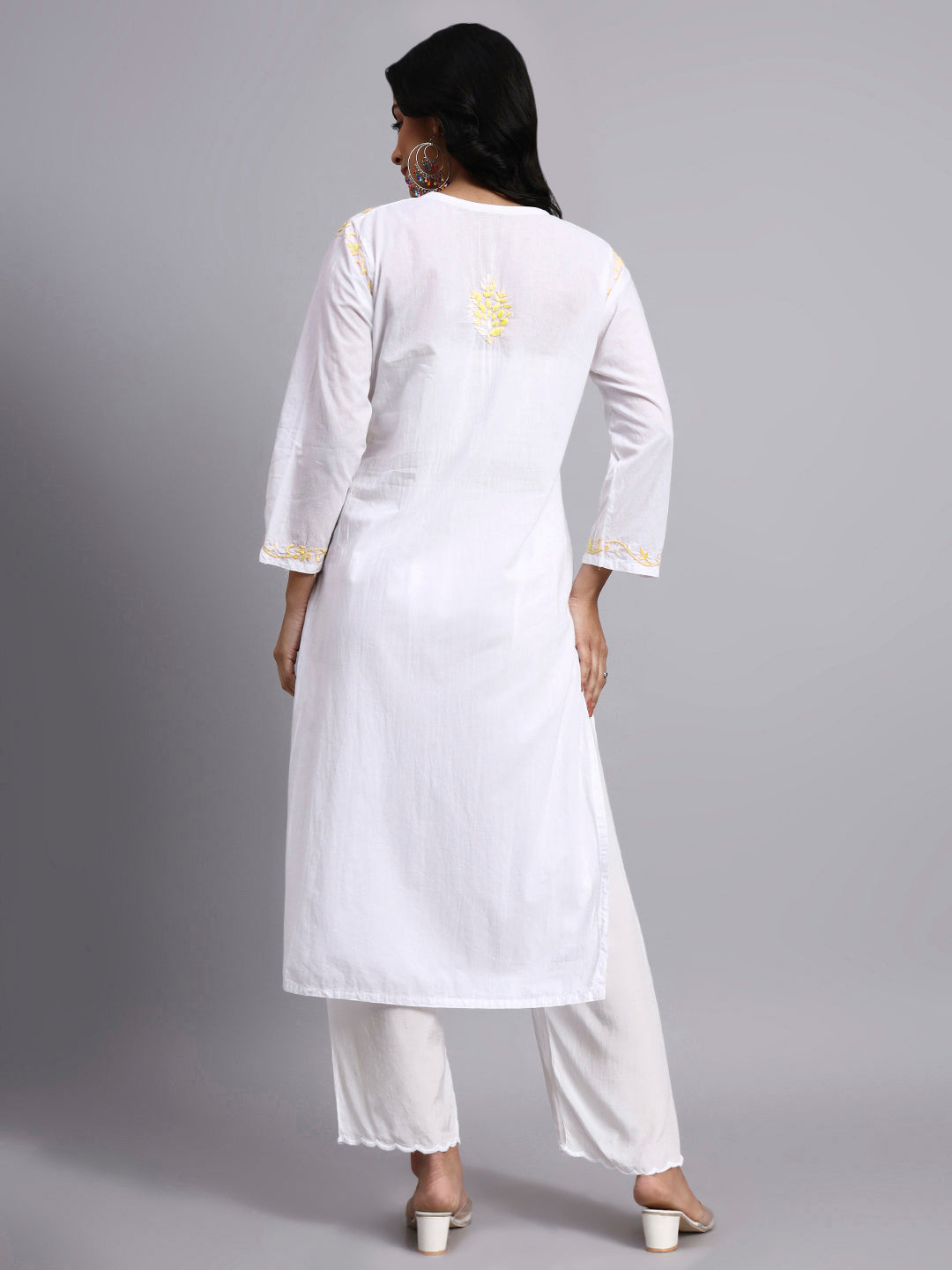 Back view of Woman wearing a white kurta with lemon embroidery on a gray background