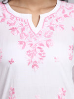 lose up view of White garment with pink floral embroidery on a white background