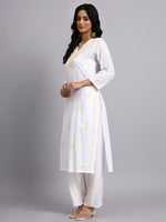 Side view of Woman wearing a white kurta with yellow embroidery on a gray background