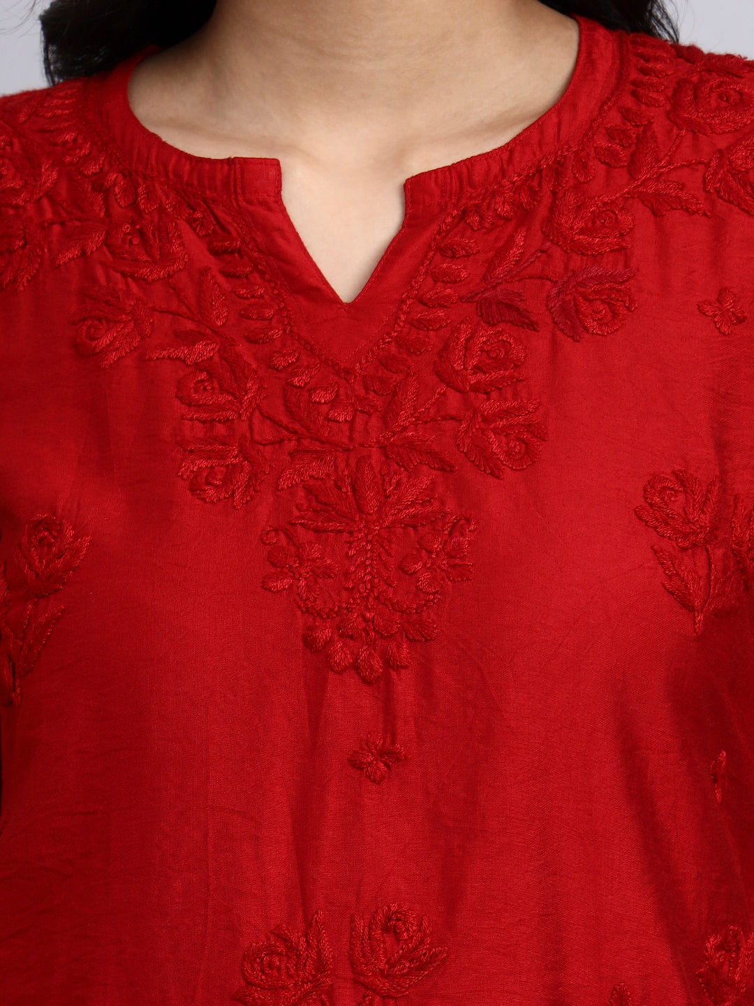 Close up view of Red embroidered garment with intricate patterns