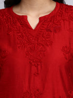 Close up view of Red embroidered garment with intricate patterns