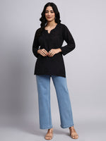 Full view of Woman wearing a black top and blue jeans on a gray background