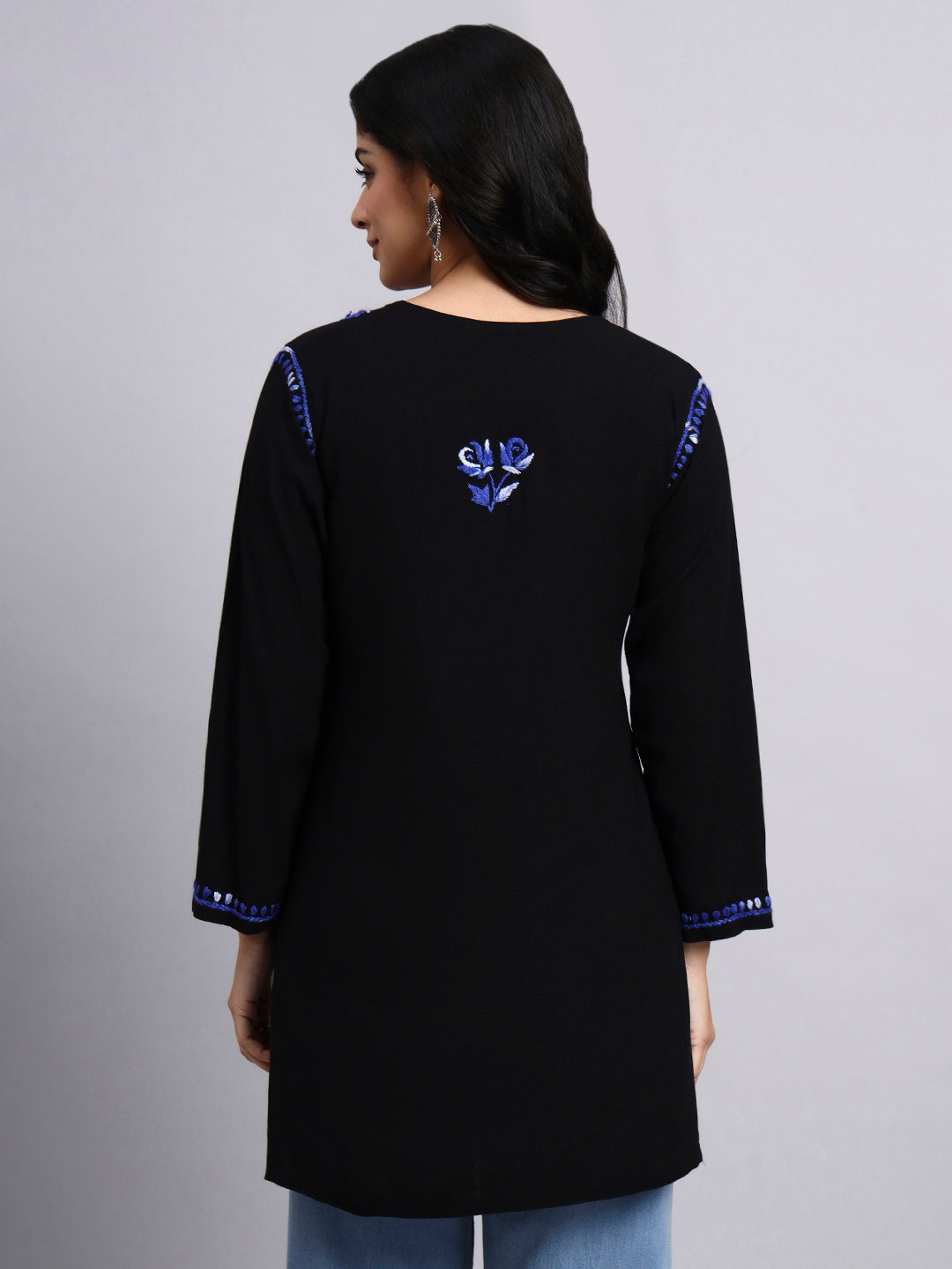 Back view of Black kurta with blue embroidery on a gray background