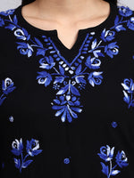 Close up view of Black fabric with blue floral embroidery