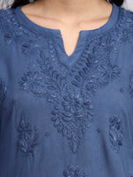 Close up view of Blue embroidered garment with intricate patterns
