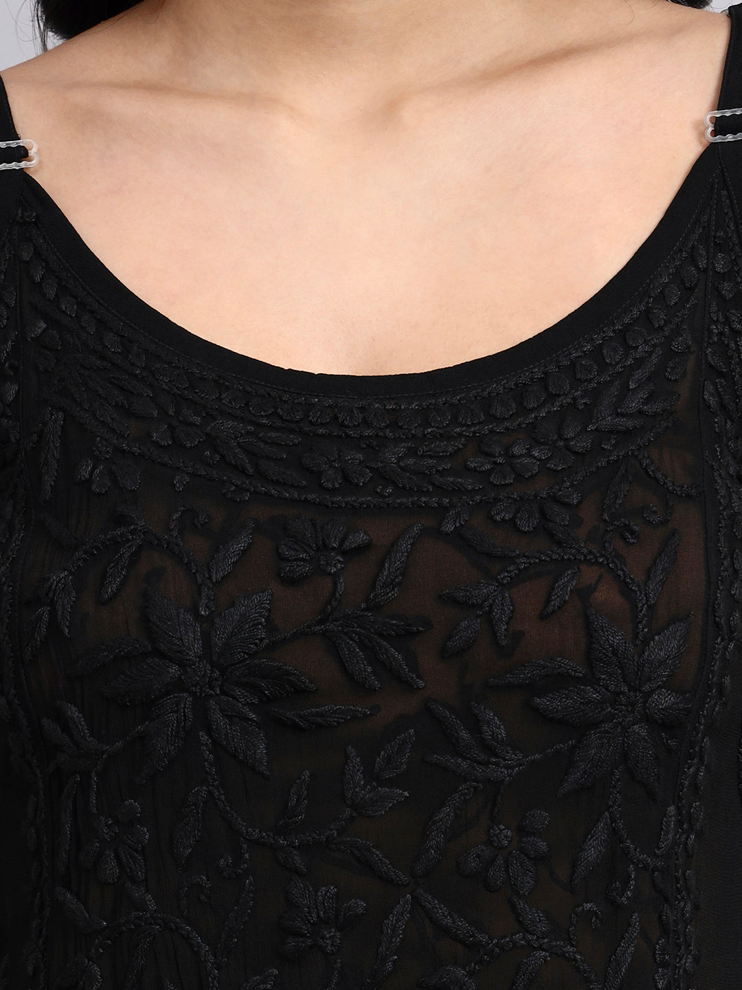 Black embroidered dress with a close-up of the neckline