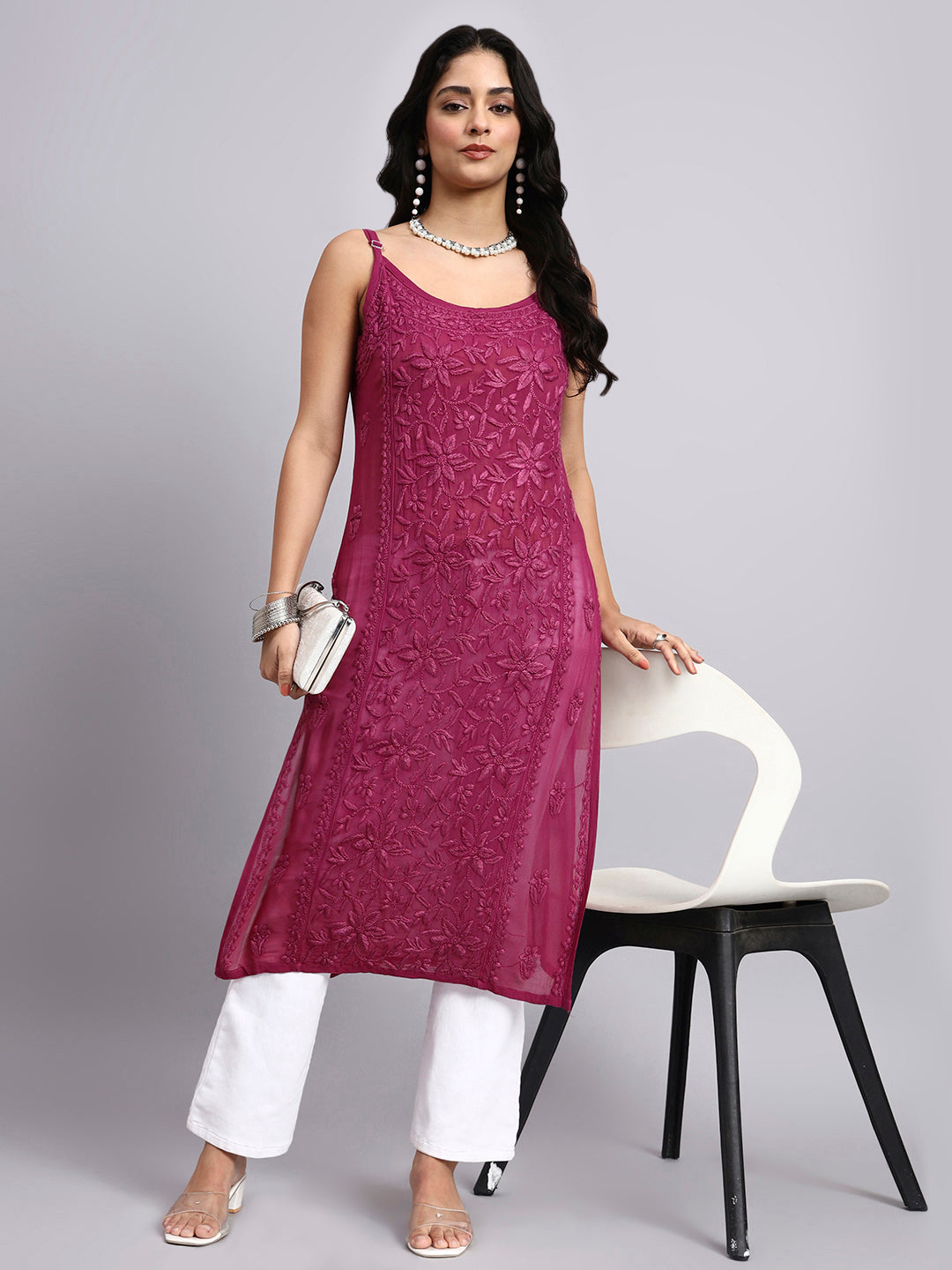 Full look of Woman wearing apink kurta with white pants on a gray background