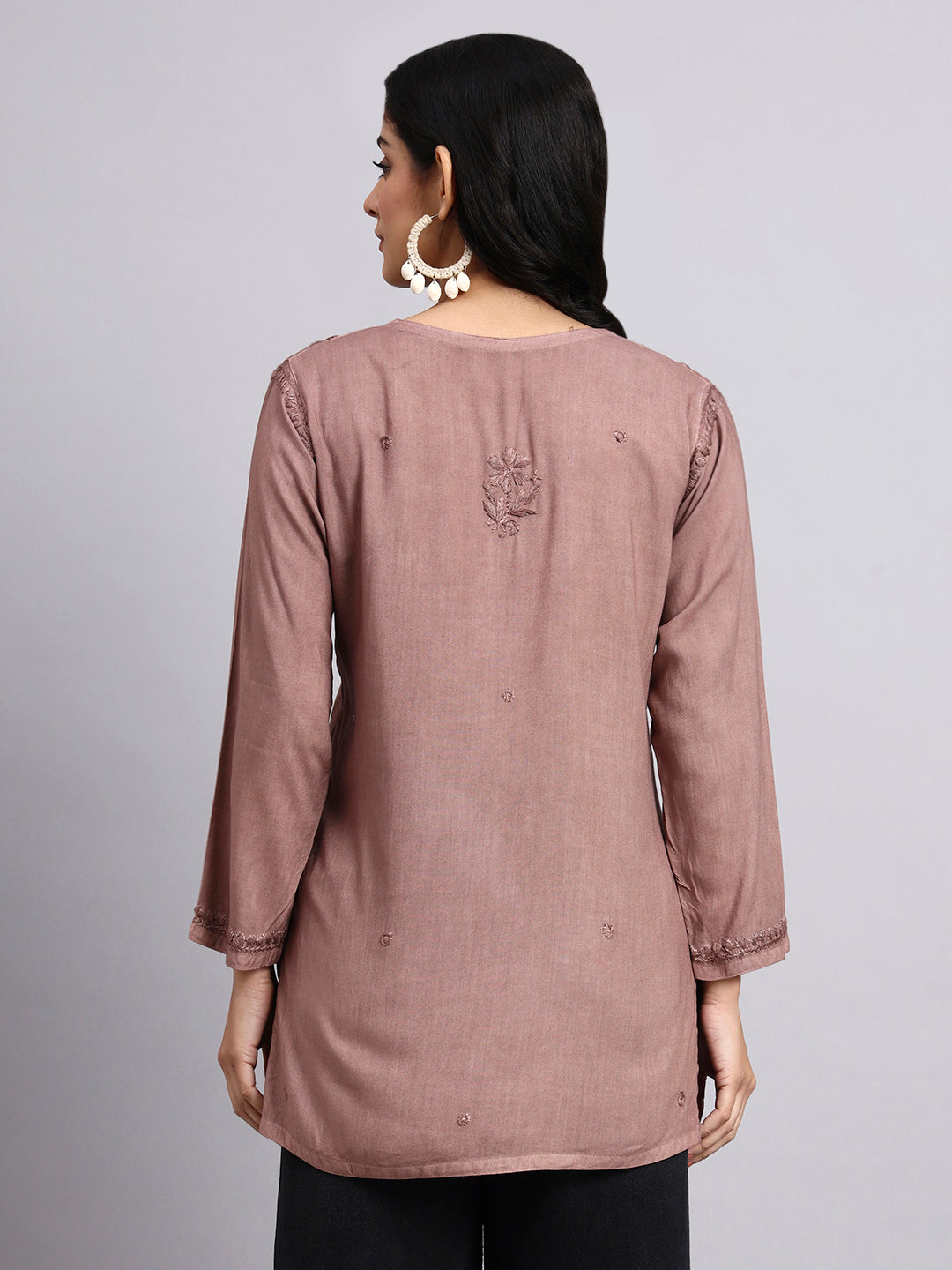 Back view of Woman wearing a brown long-sleeve kurta against a gray background