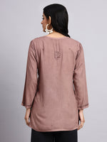 Back view of Woman wearing a brown long-sleeve kurta against a gray background
