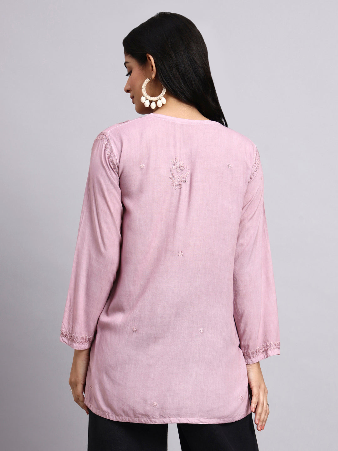Back View of Woman wearing a pink Short Kurta with a subtle design on a gray background
