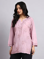 Woman wearing a pink embroideredchikankari cotton kurta.