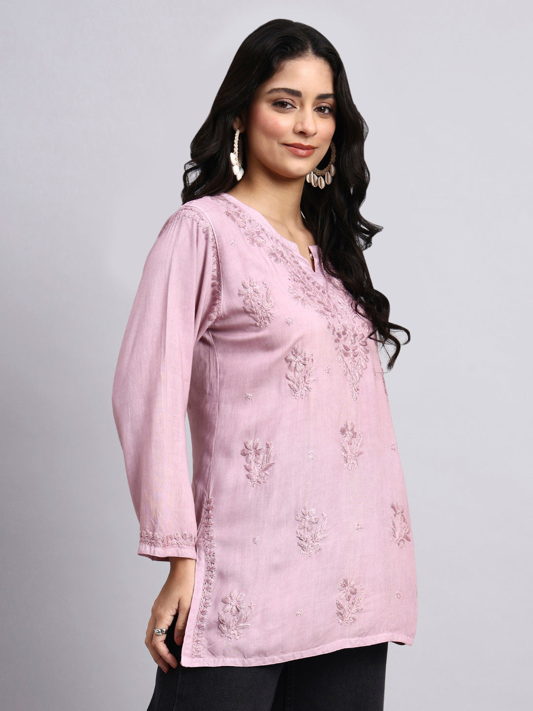 Side View of Woman wearing a pink floral Short Kurta against a gray background